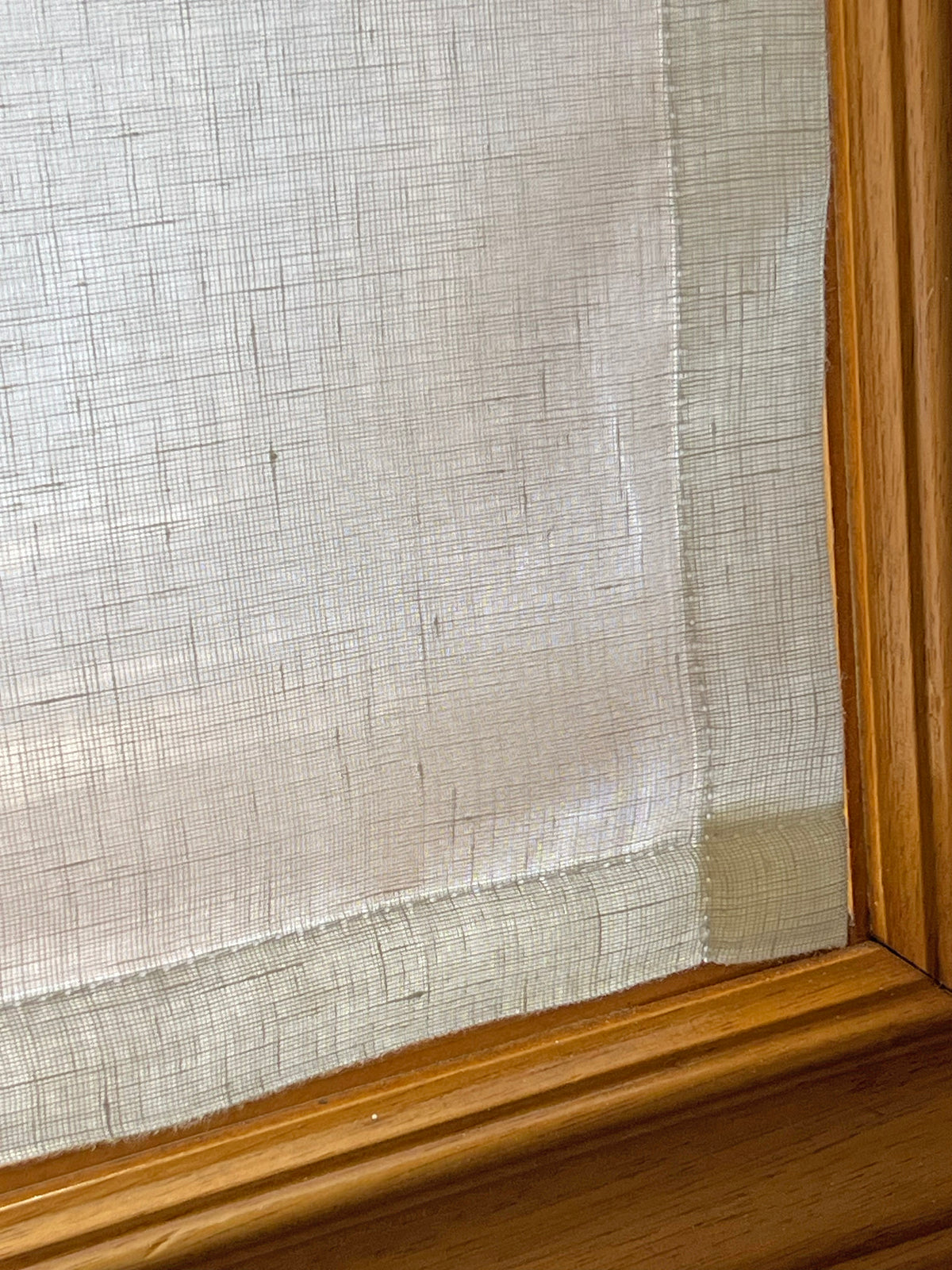Close-up of the deep, perfectly level bottom hem on a flat-style Utopia Natural sheer linen cafe curtain