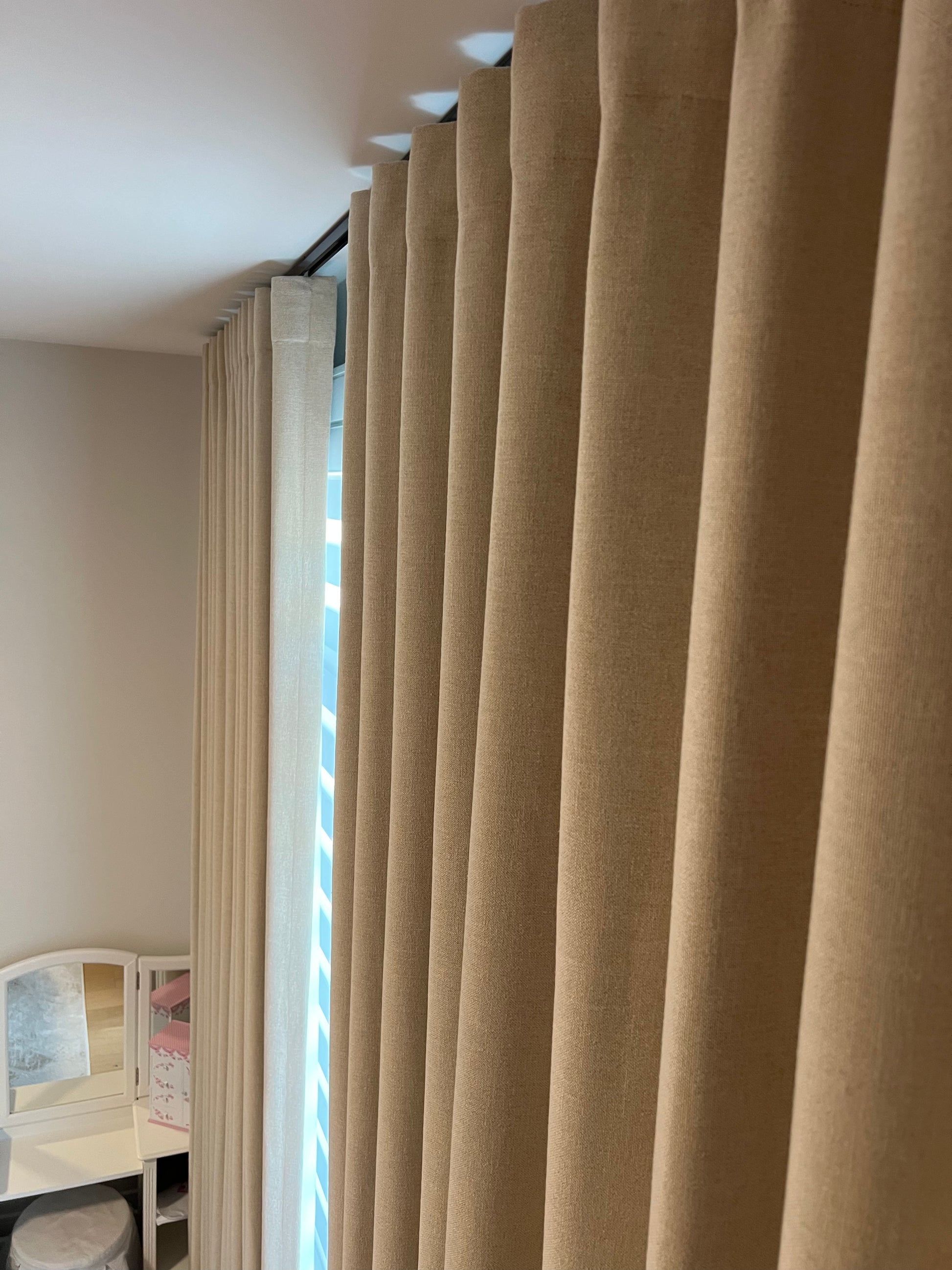 Far ripple fold drapery panel shown in a styled interior setting