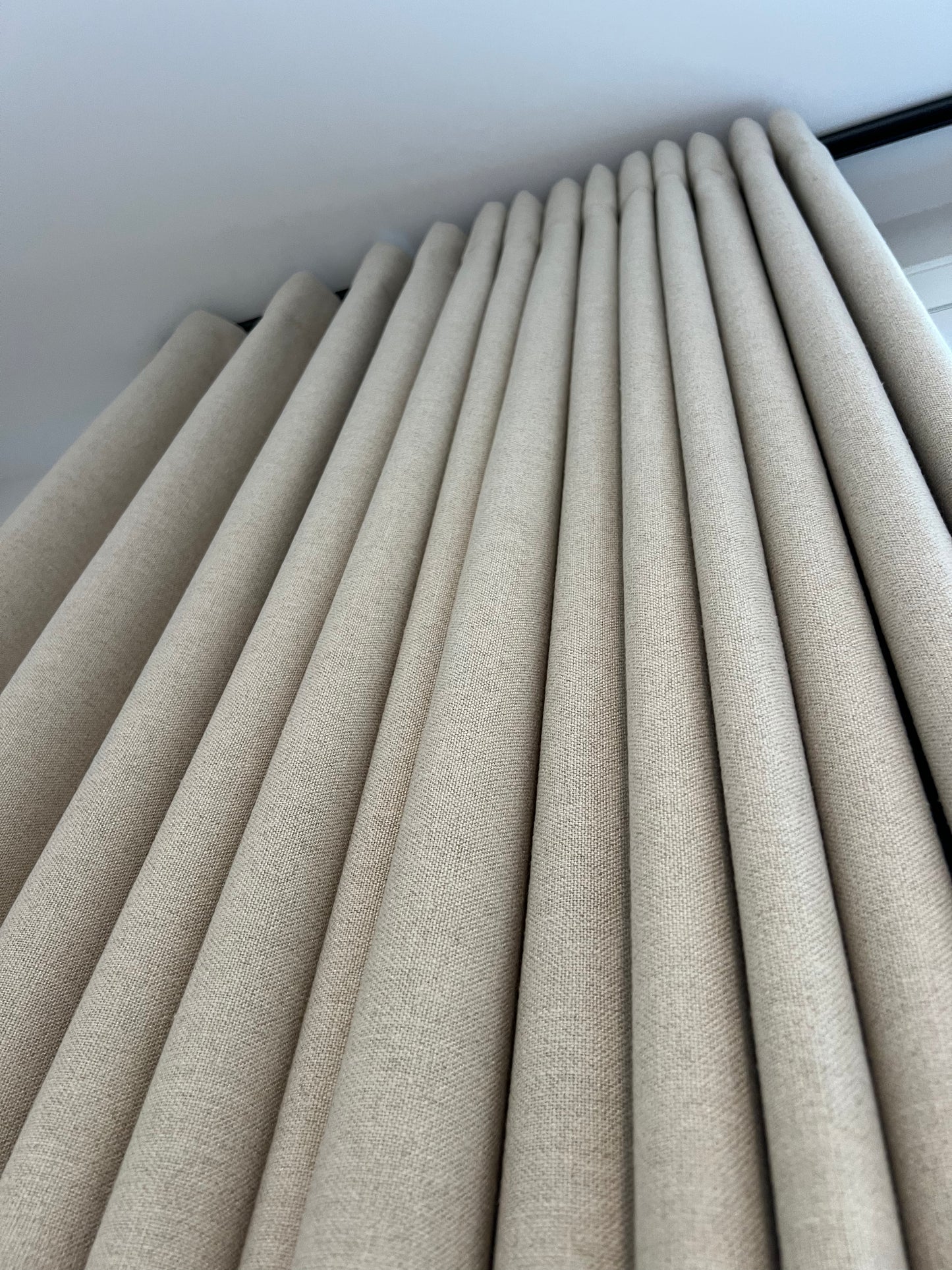 Far ripple fold drapery panel on a square track in a residential interior