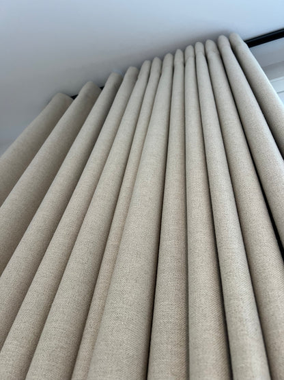 Far ripple fold drapery panel on a square track in a residential interior