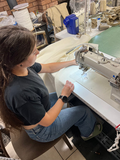 Sewing a linen café curtain in our Toronto workroom — every panel handmade by LOGANOVA
