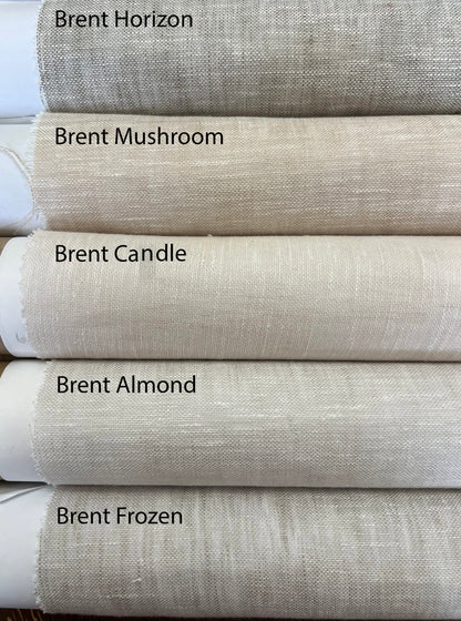 Rolled sheer linen fabrics stacked and labeled Brent Horizon, Brent Mushroom, Brent Candle, Brent Almond and Brent Frozen