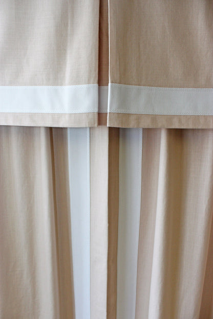 Beige and white striped drapery with white top trim