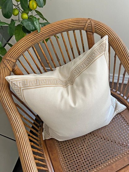 Greek key trim pillow in a bedroom setting