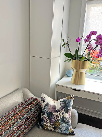 Velvet floral cushion styled on a sofa