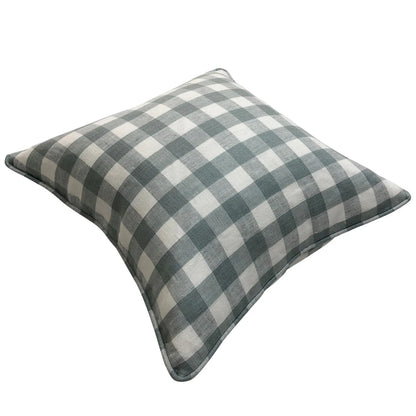 Blue and white check pillow styled on a sofa