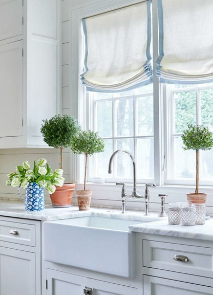 White linen relaxed Roman shade with blue border