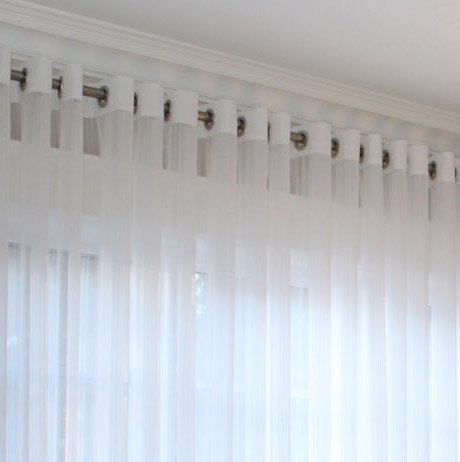 White Lucky sheer grommet drapery panel hanging on a white curtain rod