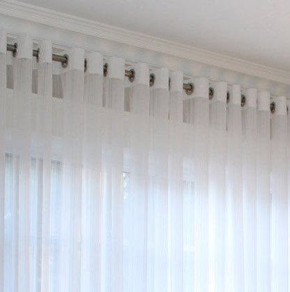 White Lucky sheer grommet drapery panel hanging on a white curtain rod