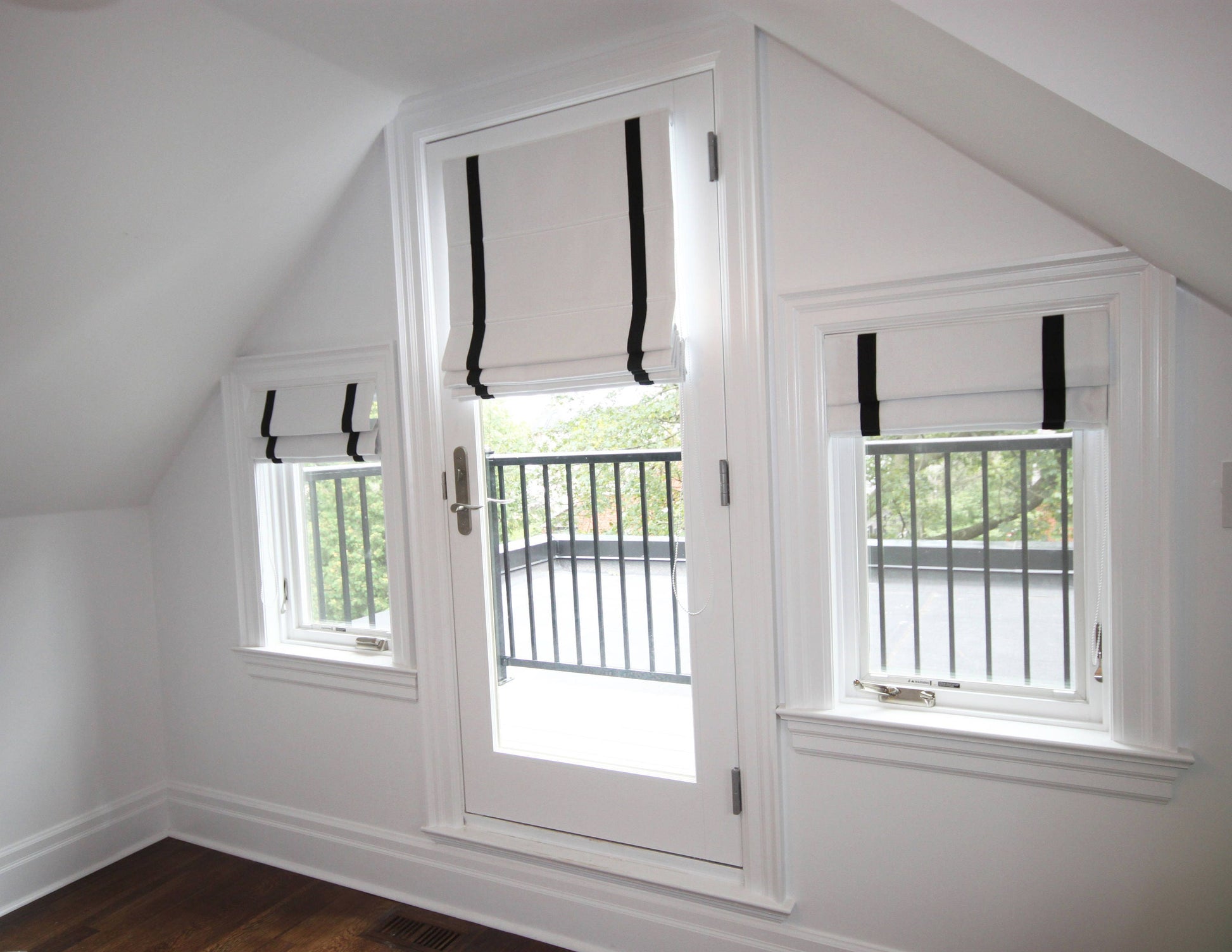 Aran linen flat Roman shades, white with black border, on three windows — custom size