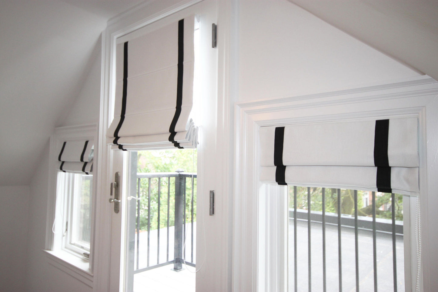 Aran white Roman shades with black border, raised — inside mount