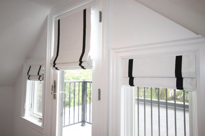 Aran white Roman shades with black border, raised — inside mount