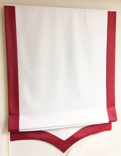 Close-up of the scalloped bottom edge and contrast border on a relaxed roman shade