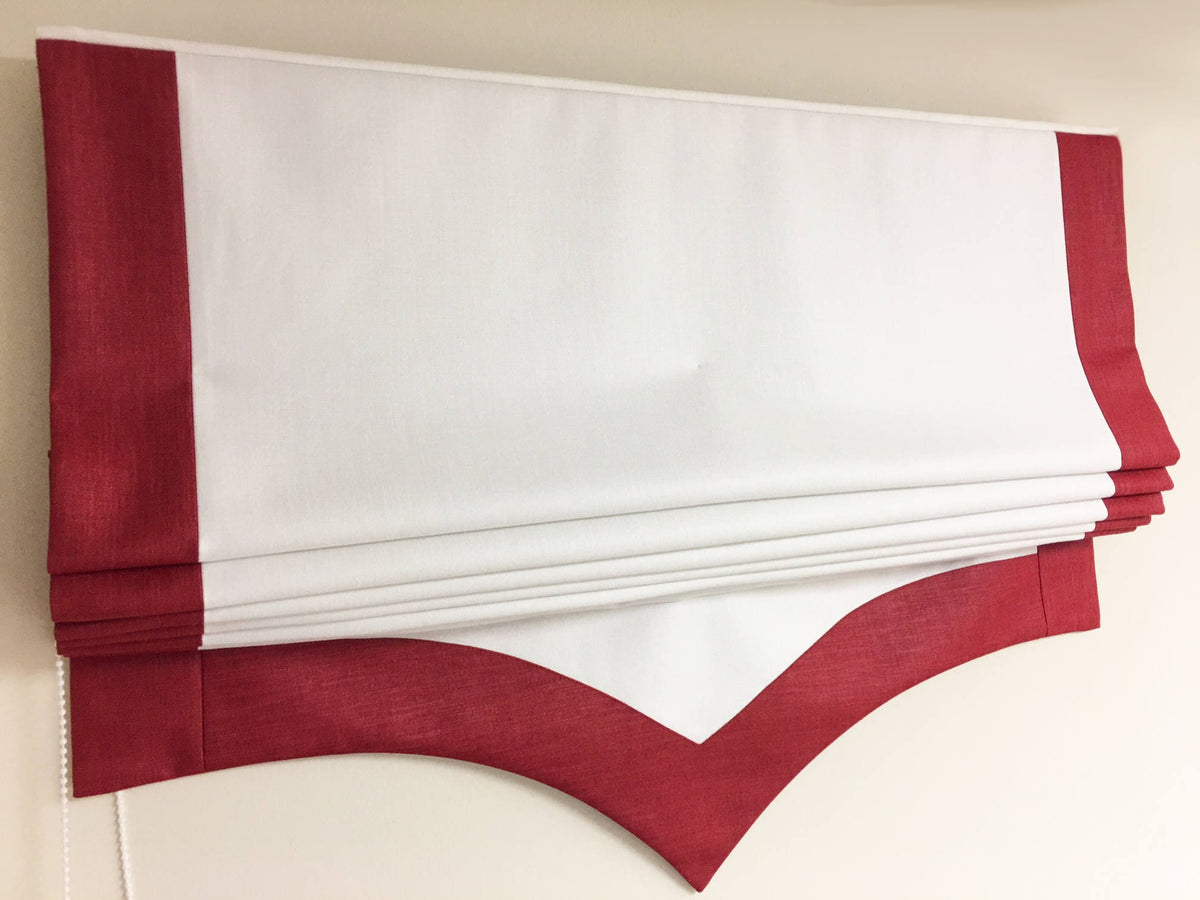 Side border detail of a handmade relaxed roman shade with scalloped trim