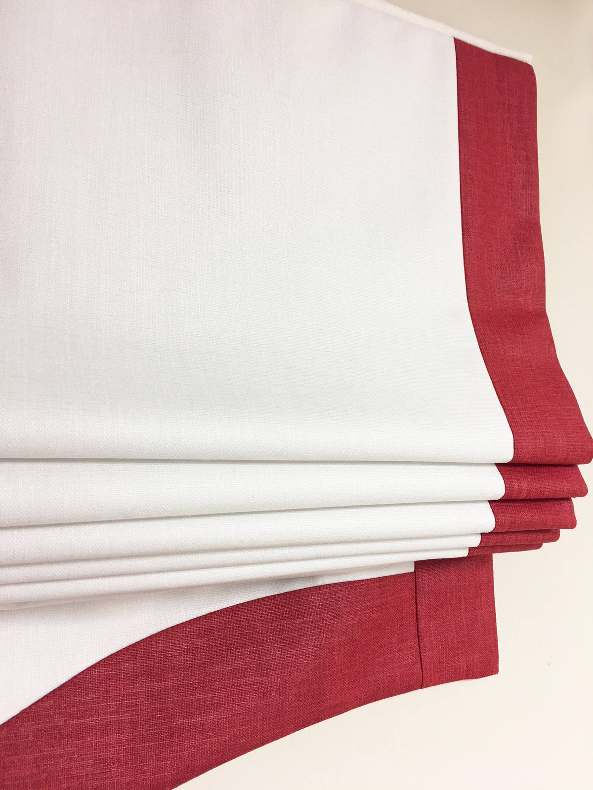 Relaxed roman shade raised, showing the soft curve of the bottom fold