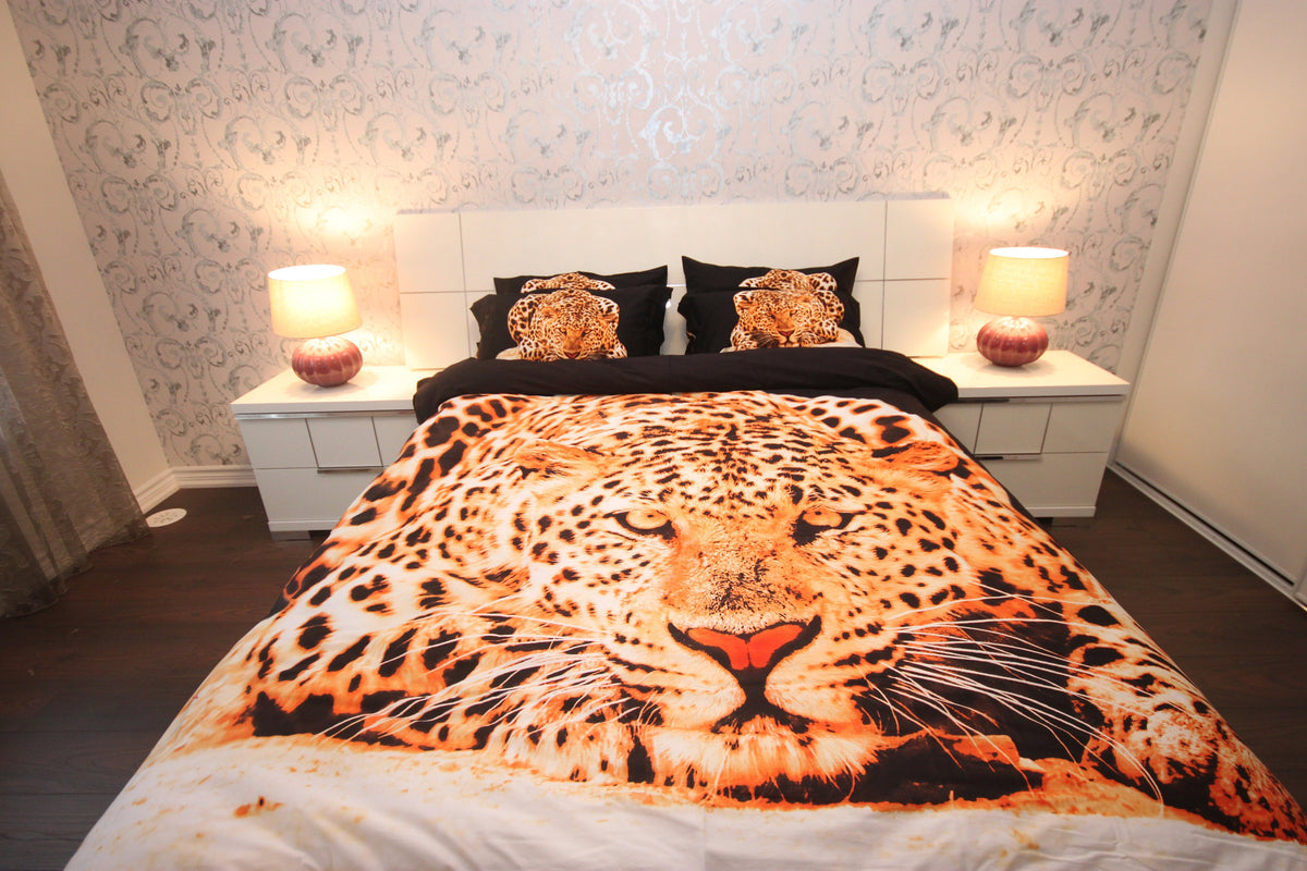 Leopard print bedding styled with wood and linen in a bedroom