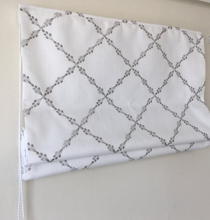 Ryder Silver relaxed Roman shade in white faux linen with grey embroidered sprig pattern