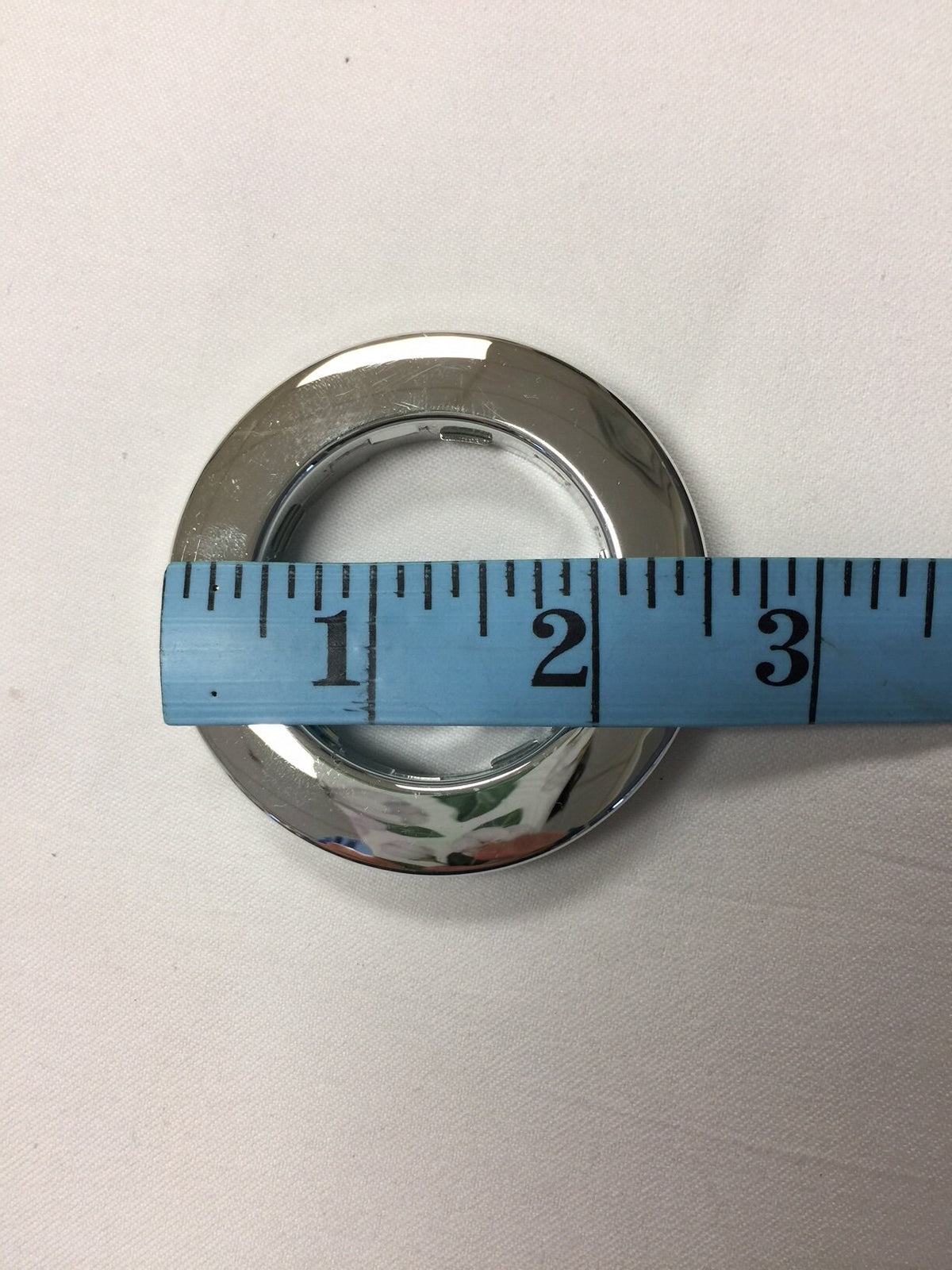 Silver grommet measured with a tape at 2 inches inner diameter
