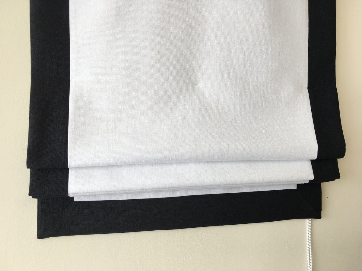 Made to order relaxed Roman shade, white faux linen with black edge