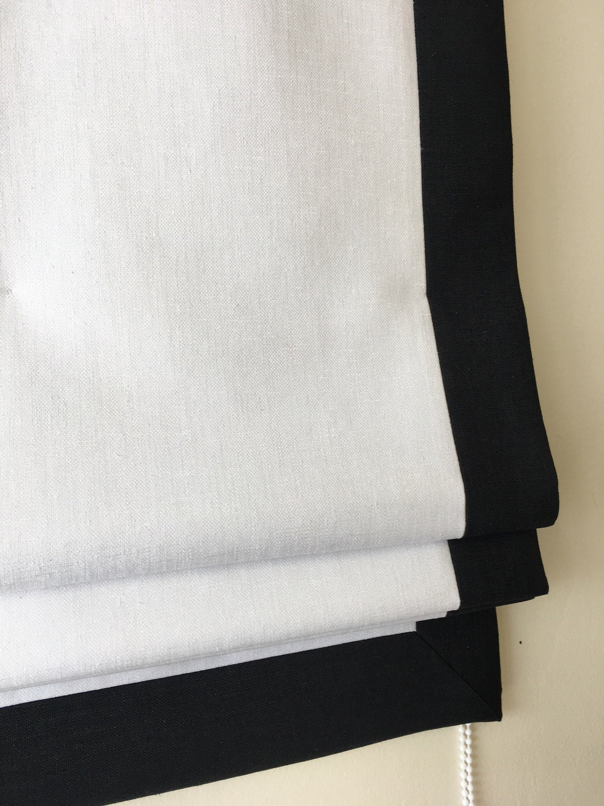 White Roman shade with black border, handmade window treatment