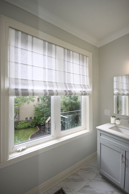 Flat Roman shade in white linen with grey stripes on a bathroom window — LOGANOVA