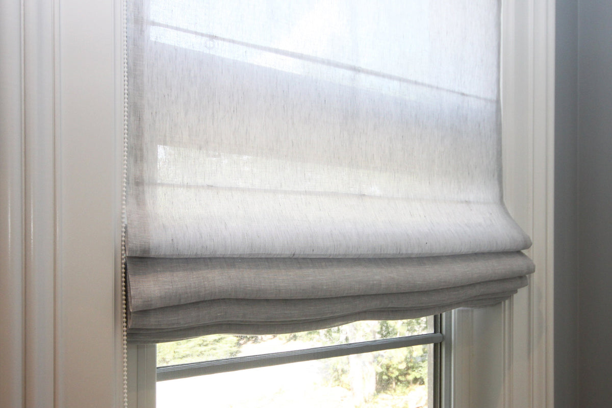 Sheer linen Roman shade — soft relaxed fold with daylight coming through