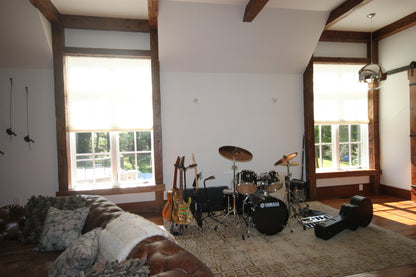 Music room with tall windows in light-filtering linen Roman shades — LOGANOVA