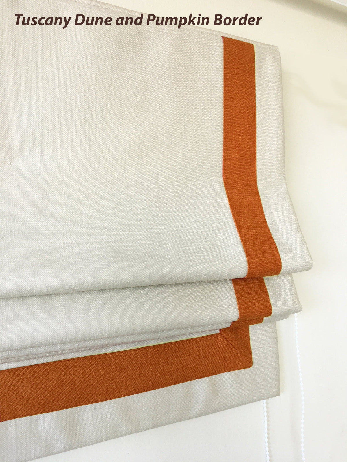 Detail of the top of the relaxed Roman shade with decorative piping