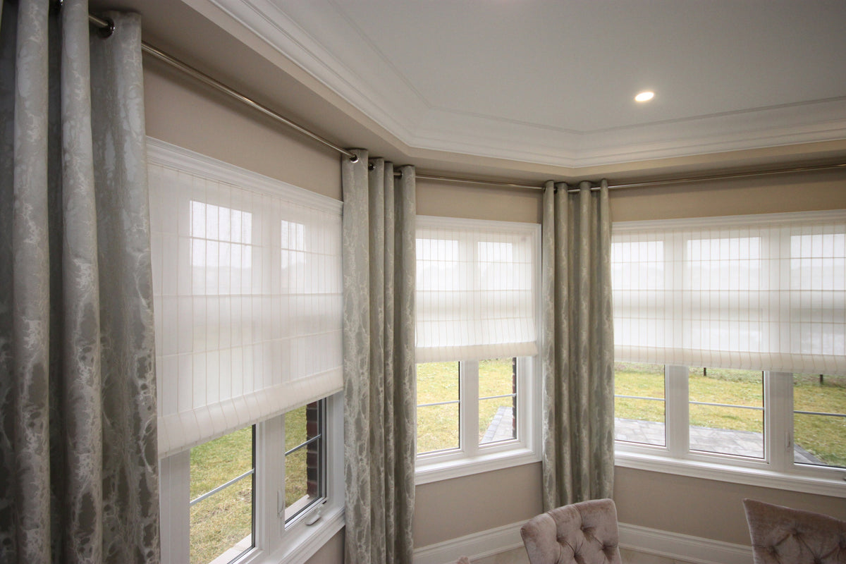Josh sheer faux linen flat Roman shade in a window