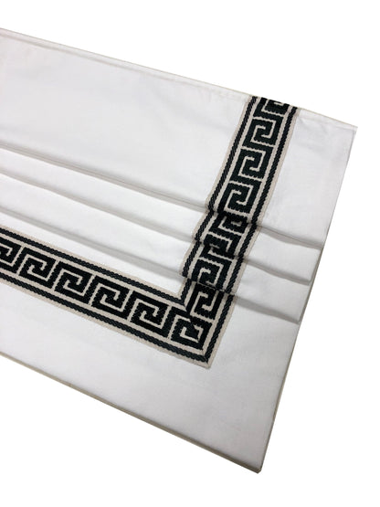 Black and taupe Greek key border framing the corner of the white valance — LOGANOVA