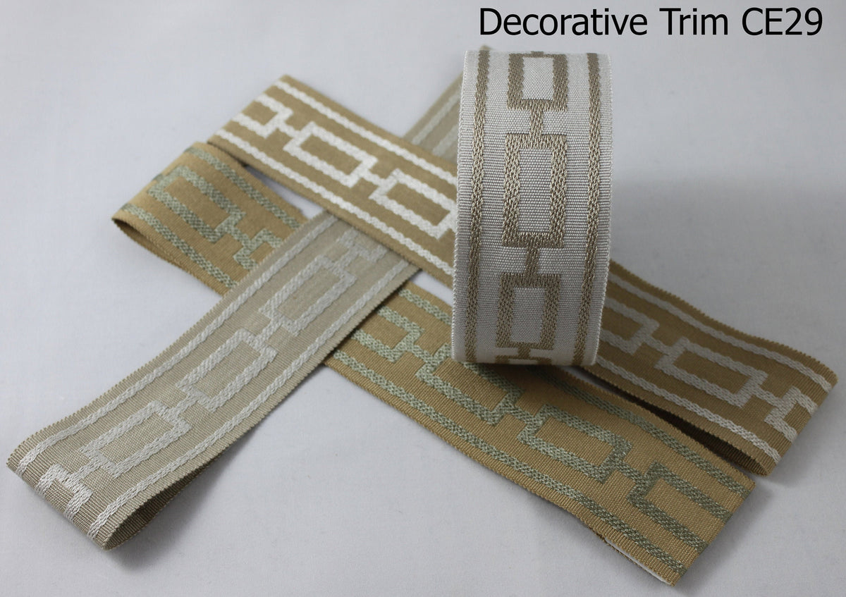 Close view of the woven geometric decorative trim on a Cheval Roman shade