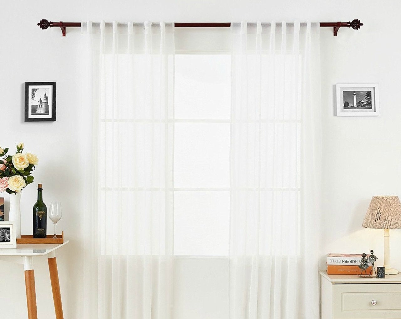 Hidden tab top sheer panel on a dark rod in a living room — LOGANOVA
