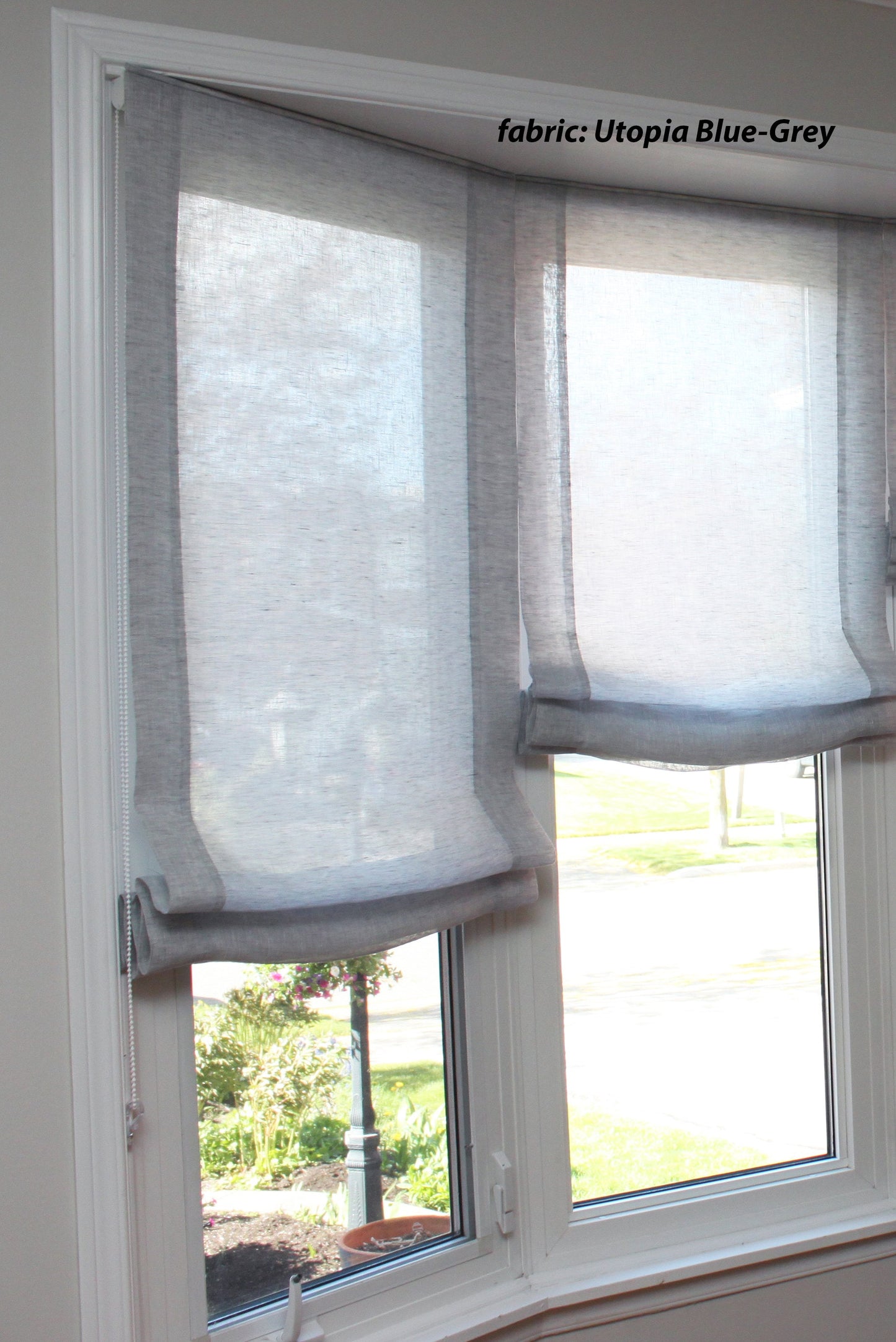 Utopia Blue-Grey sheer linen relaxed Roman shades on a corner window — LOGANOVA