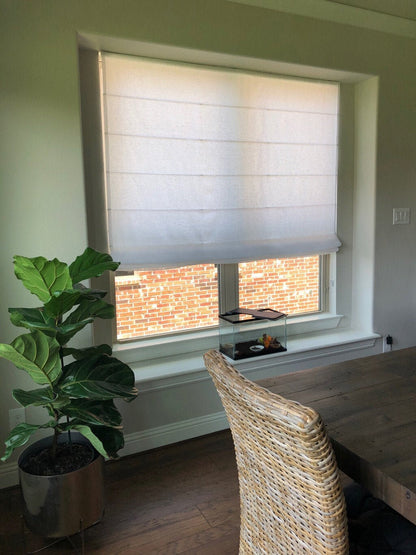 Sheer linen Roman shade with weighted bar and piping detail