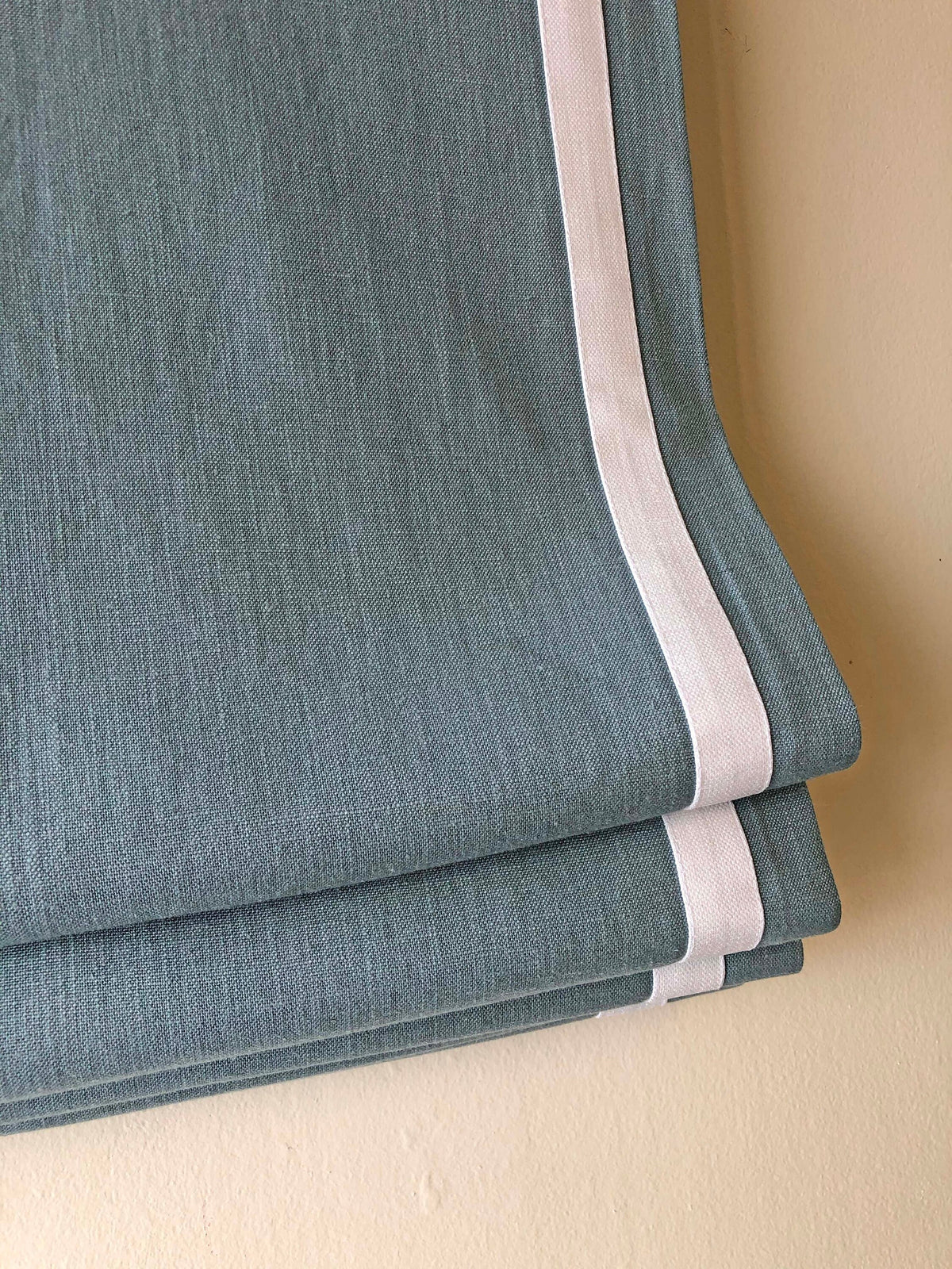 Close-up of the relaxed fold and weighted hem on a Regatta linen shade