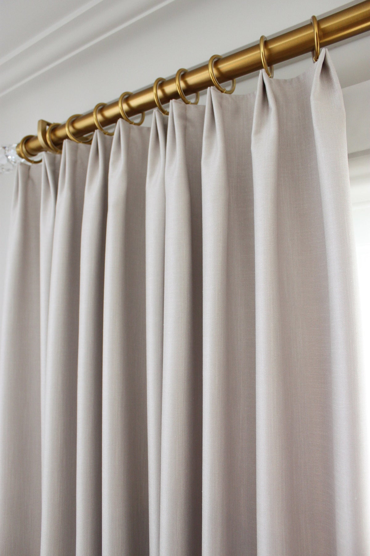 Solid colour faux linen drapery panels in a styled room