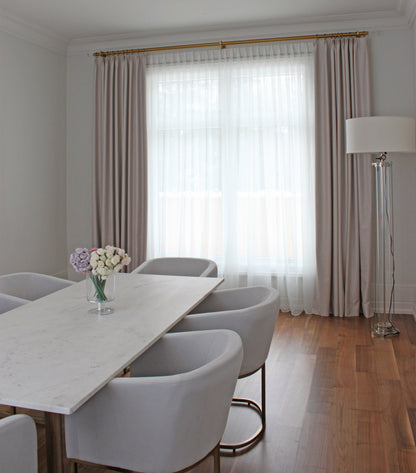 Cheval faux linen pinch pleat drapery panel hanging at a window