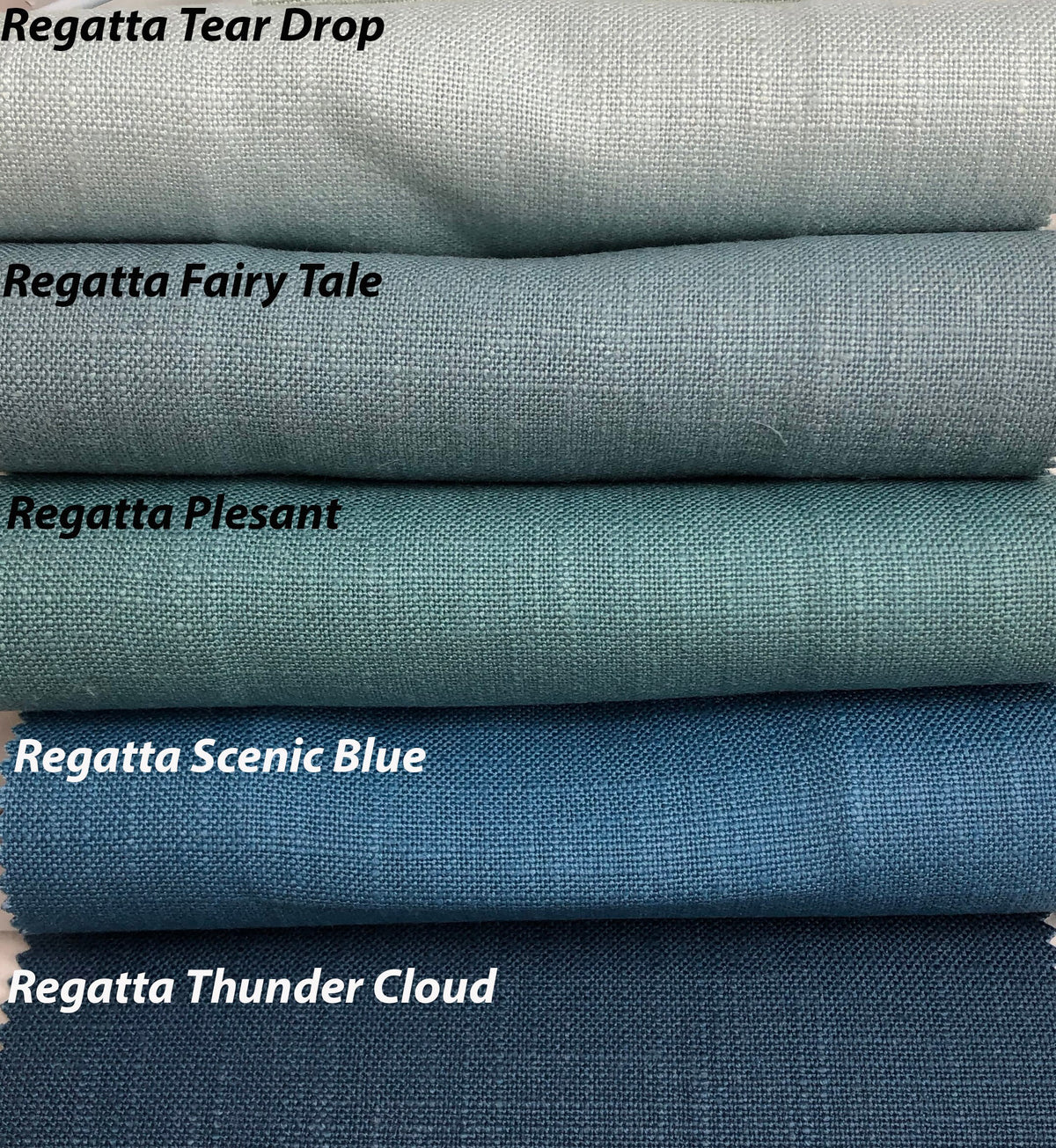 Regatta linen Roman shade shown raised into soft relaxed folds
