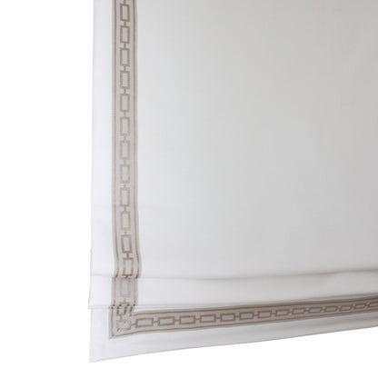 Waterfall bottom hem of a relaxed Roman shade showing the soft curve and weighted bar