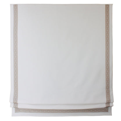 Beige linen Roman shade with Greek key border mounted inside a window frame