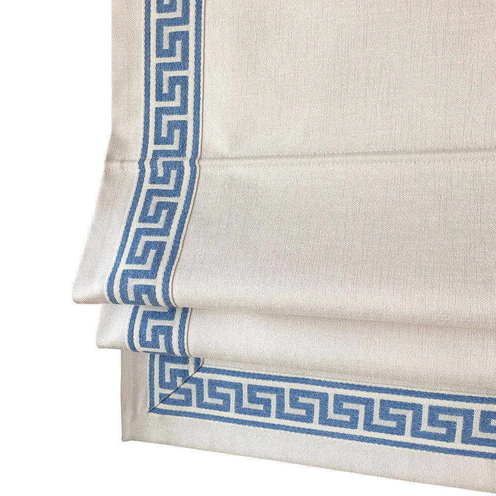 White Cheval faux linen flat Roman shade with a blue Aristotle Greek key border