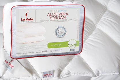 Quilted comforter shown on a made bed as a duvet cover insert