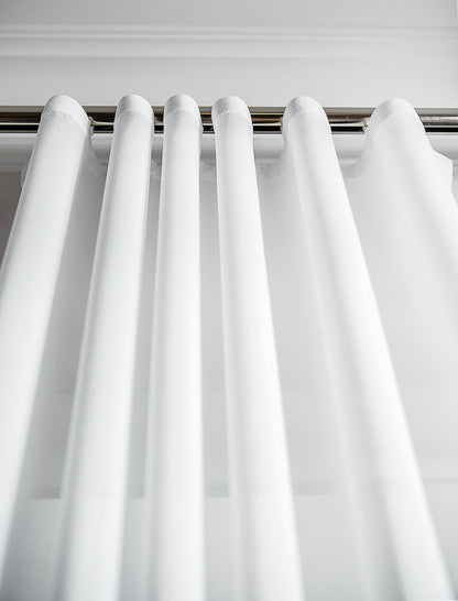 Close view of the Kidman sheer fabric showing its fine grain and matte finish along an s-fold curve