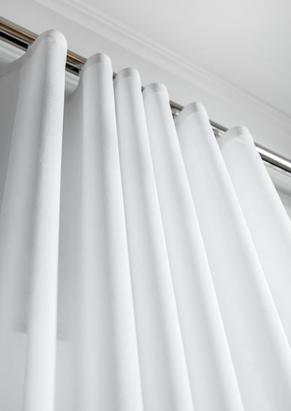 Kidman privacy sheer ripple fold curtain hanging in soft even s-fold waves across a bright living room window