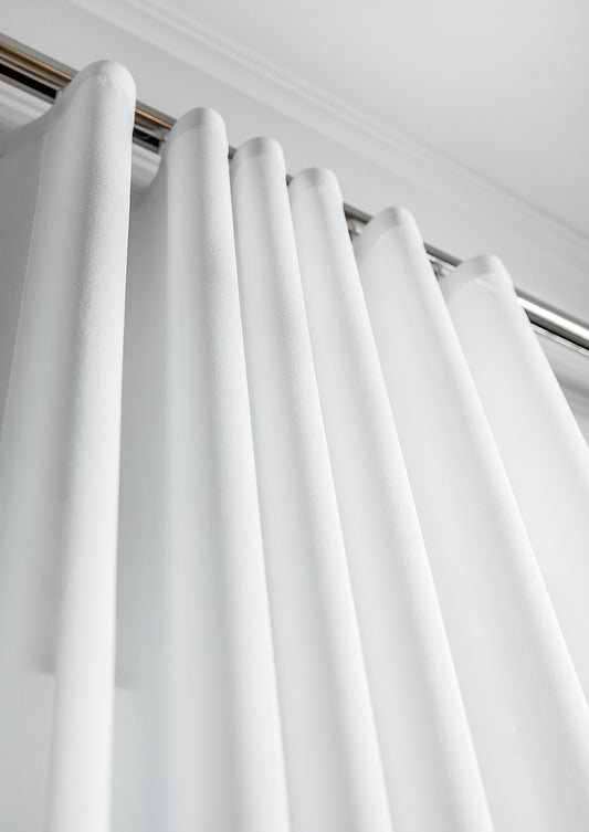 Kidman privacy sheer ripple fold curtain hanging in soft even s-fold waves across a bright living room window