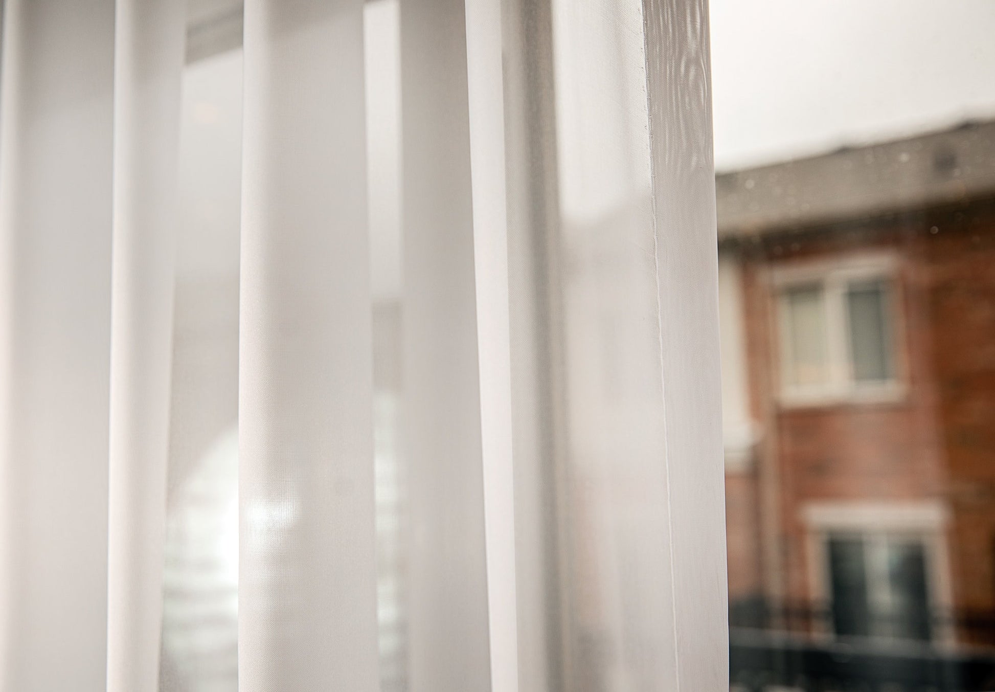 Empire sheer softening the view, panel in front of window — LOGANOVA