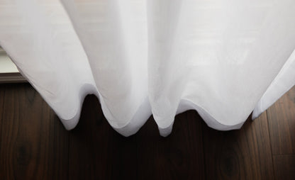 Dallas sheer drapery in soft folds over a dark wood floor