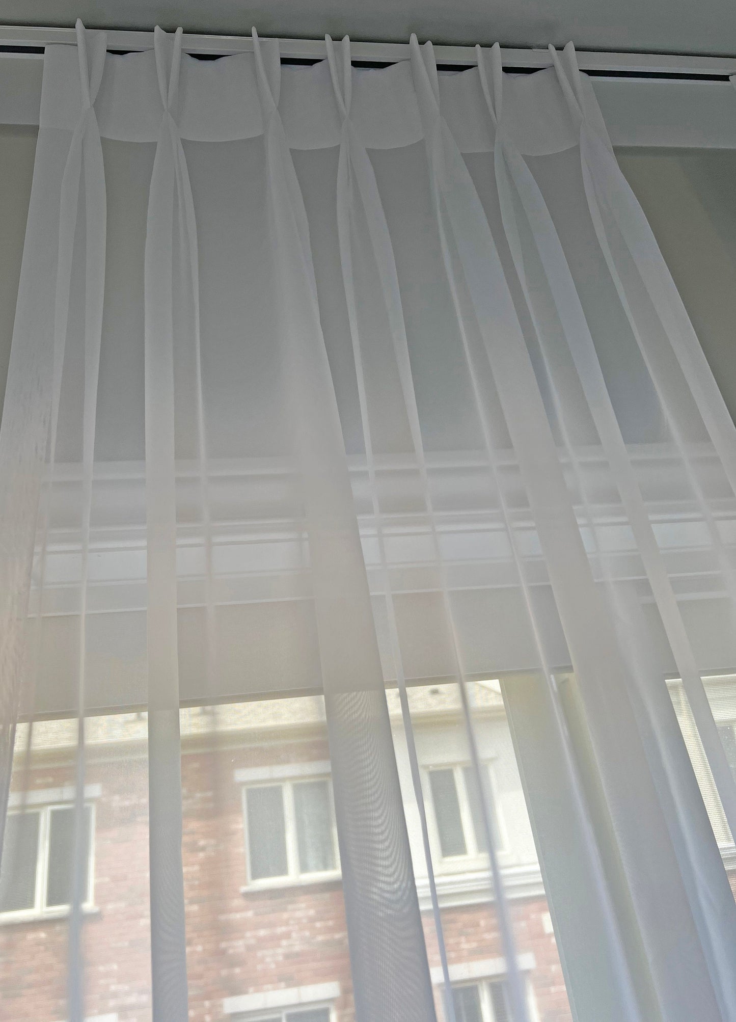 Daylight filtering through Empire voile pinch pleat sheer — LOGANOVA