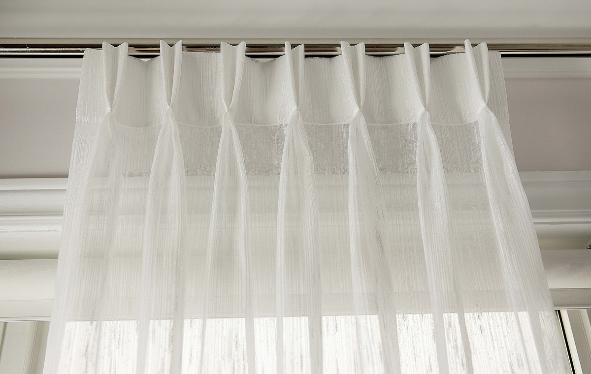 Lugano sheer pleated curtains filtering daylight in a room
