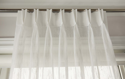 Lugano sheer pleated curtains filtering daylight in a room